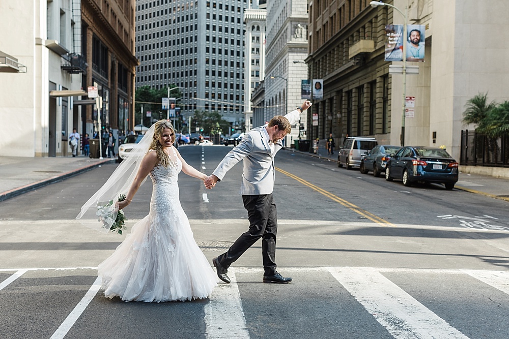 Bride and groom walk across street at San Francisco City Club Wedding by Amy Thompson Photography
