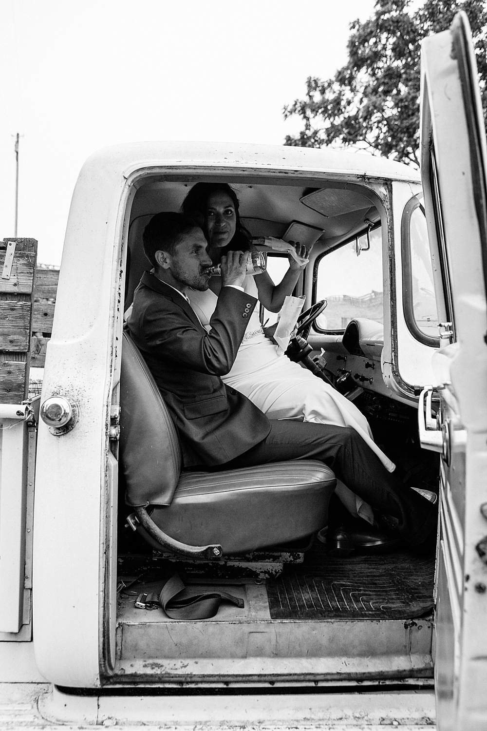 bride and groom in vintage truck at a Bloomfield farms wedding by amy thompson photography