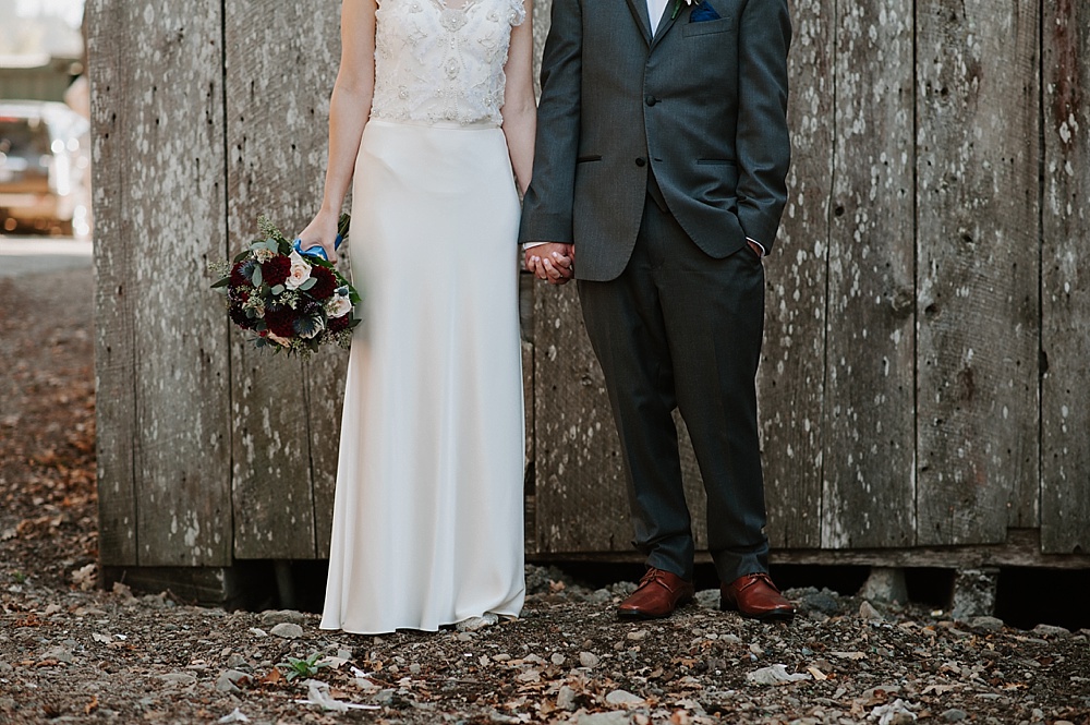 Bride and groom holding hands at Rancho Nicasio wedding by amy thompson photography