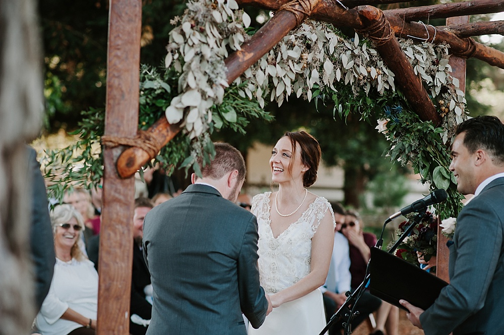 Bride laughs during wedding ceremony at Rancho Nicasio wedding by amy thompson photography