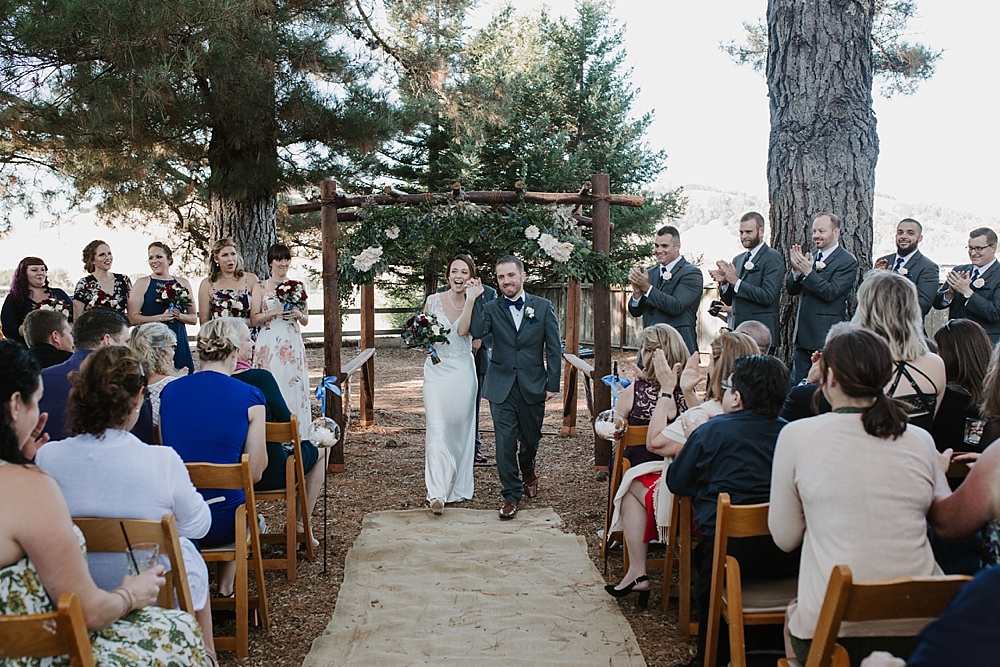bride and groom walk down rancho nicasio aisle for marin county wedding venues blog by amy thompson photography