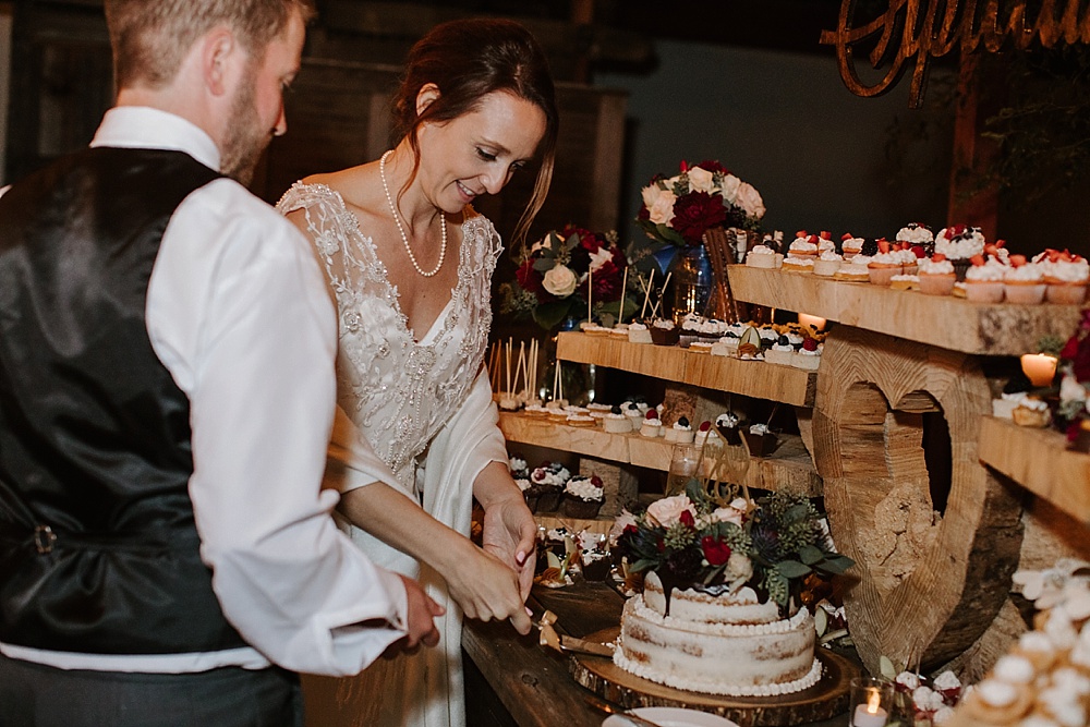 bride and groom cut into cake at Rancho Nicasio Wedding
