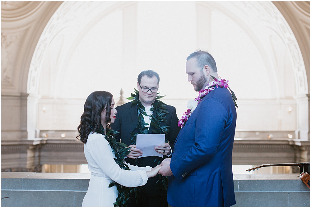 Bride and groom hold hands during San Francisco City Hall Wedding Ceremony by amy thompson photography