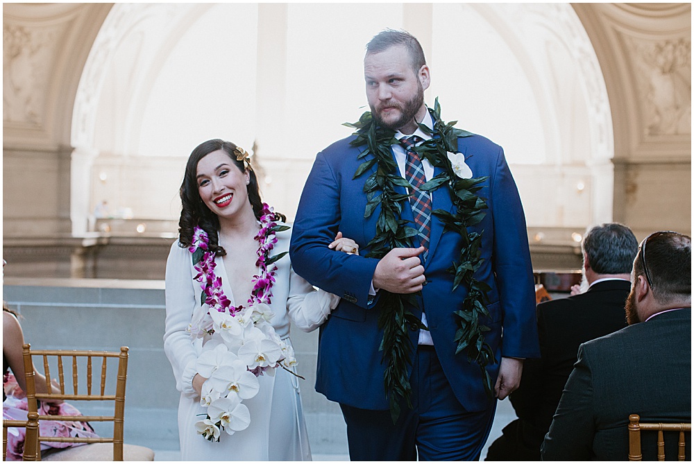 Bride and groom walk down aisle at San Francisco City Hall Wedding Ceremony by amy thompson photography