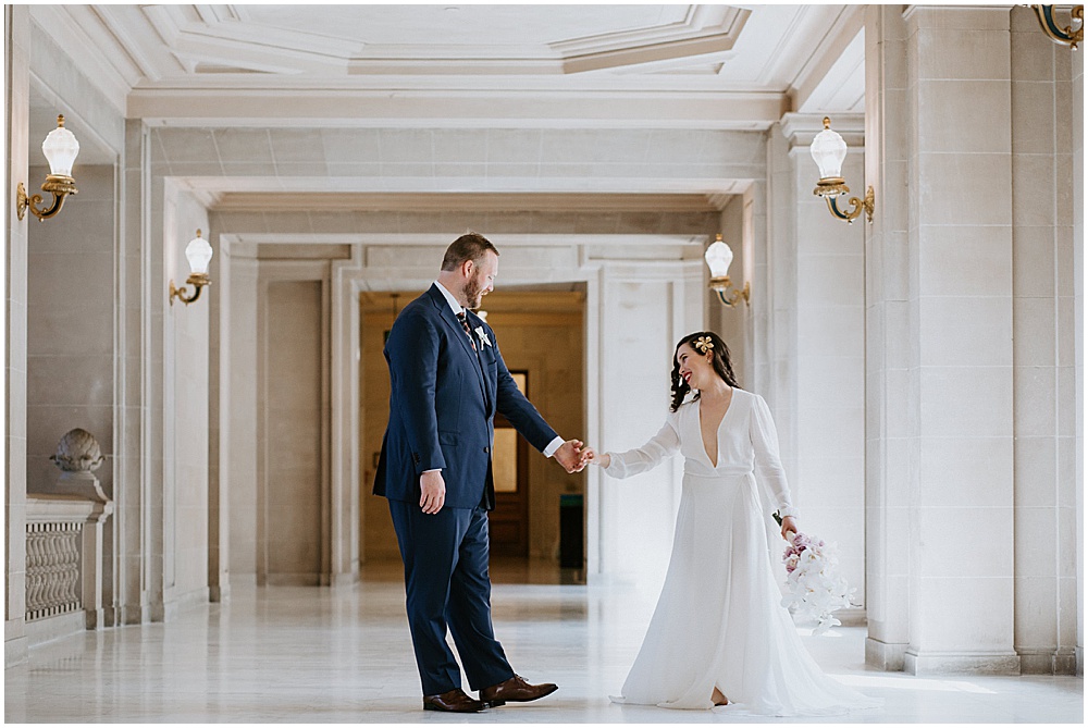 Bride and groom check each other out after San Francisco City Hall Wedding Ceremony by amy thompson photography