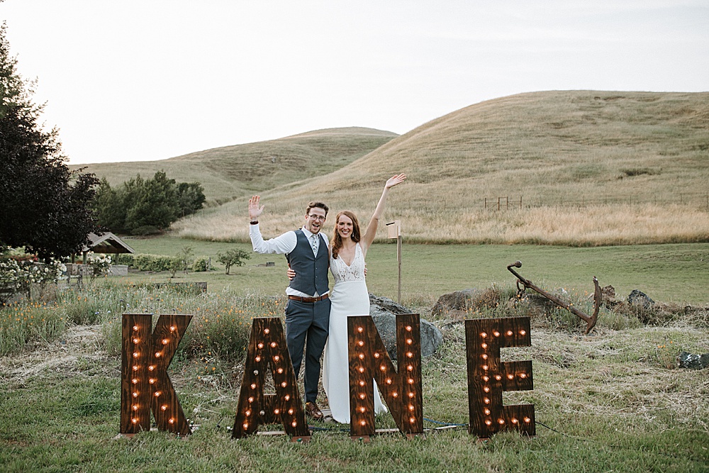 light up last name with bride and groom at Rosewood Events by amy thompson photography