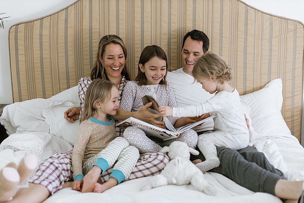 reading a book for family photo shoot at home by amy thompson photography