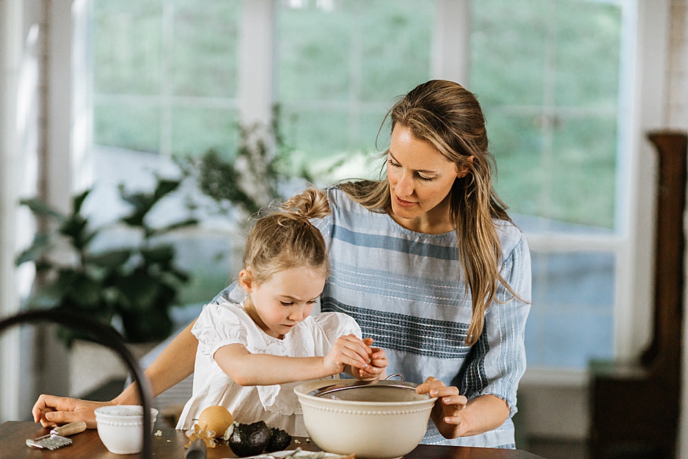 mom and daughter making snacks in kitchen for family photo shoot at home 