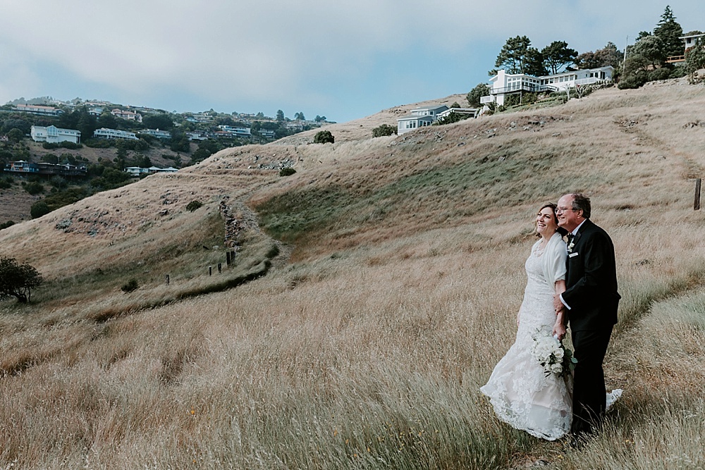 couple standing in front of the marin headlands at their marin wedding