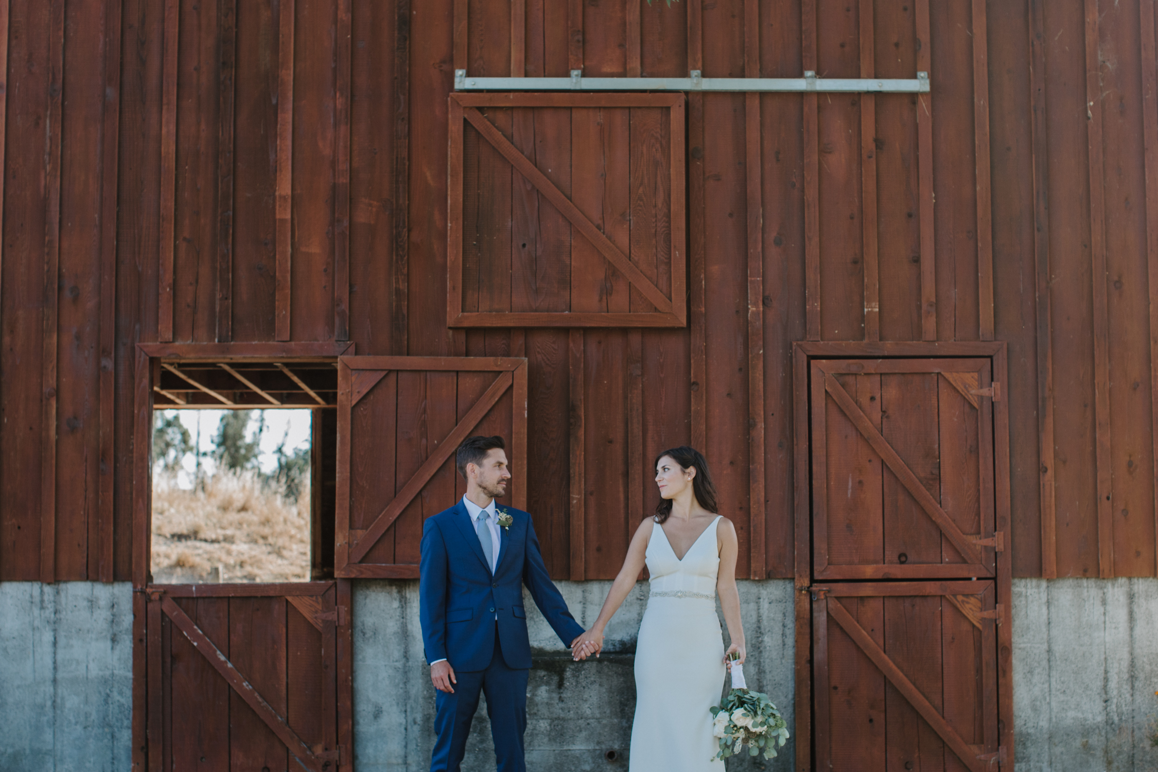 Bride and groom outside barn at a rustic petaluma wedding by amy thompson photography