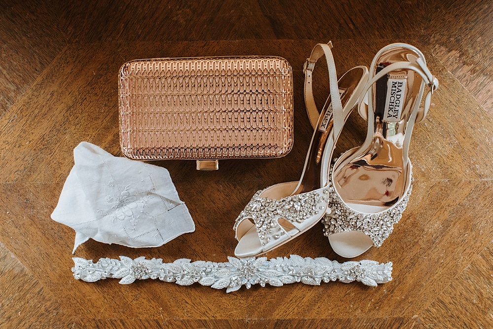 Brides shoes, clutch and bracelet at a Bloomfield farms wedding by amy thompson photography