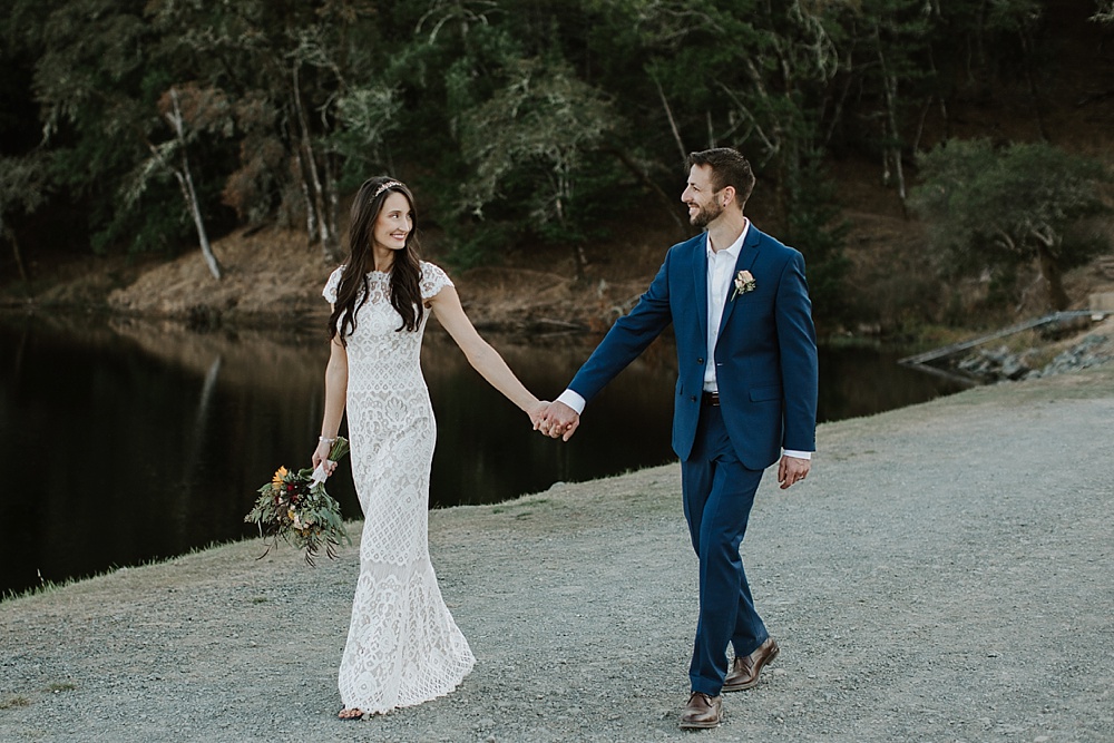 Bride and groom walk along Bon Tempe at Marin County wedding by amy thompson photography