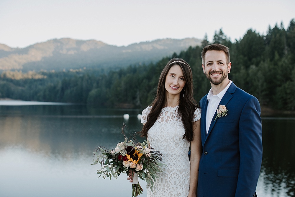 Bride and groom smile at Marin County wedding lake portrait session by amy thompson photography